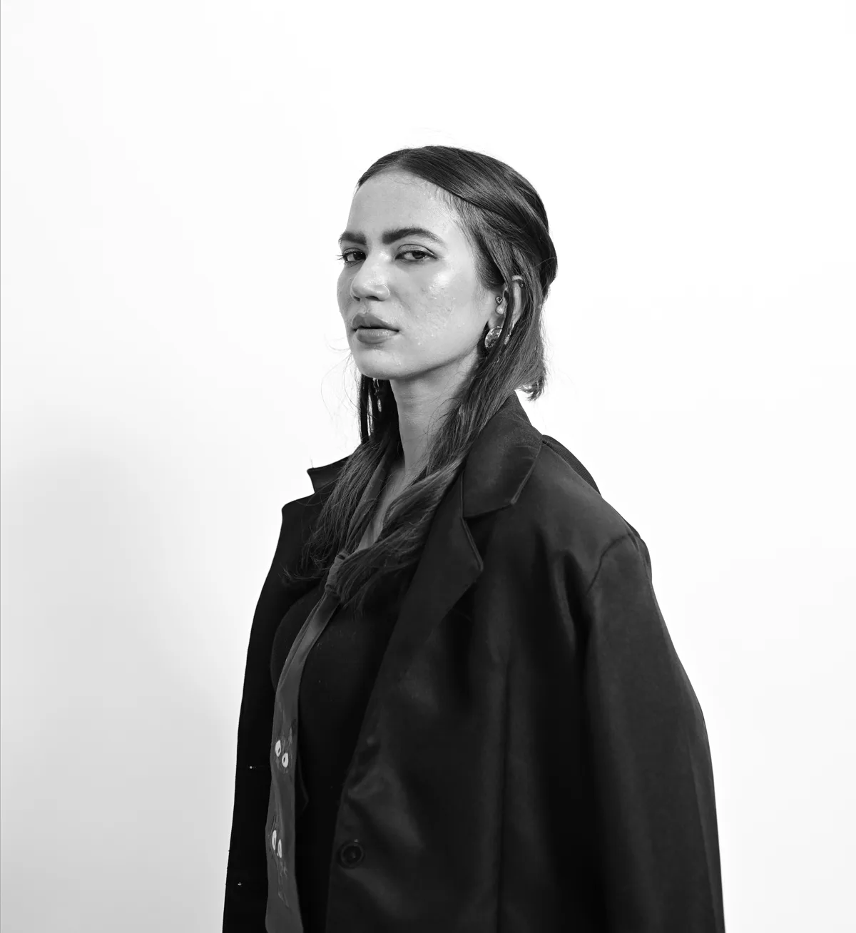 Ankita Bishaya in a tailored black coat, photographed in black and white