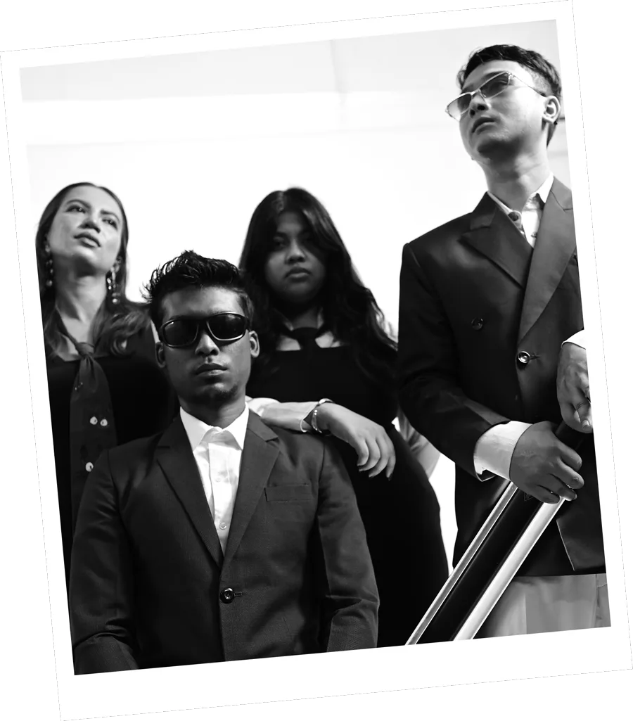 The Kazi team grouped together in black tailoring, photographed in black and white