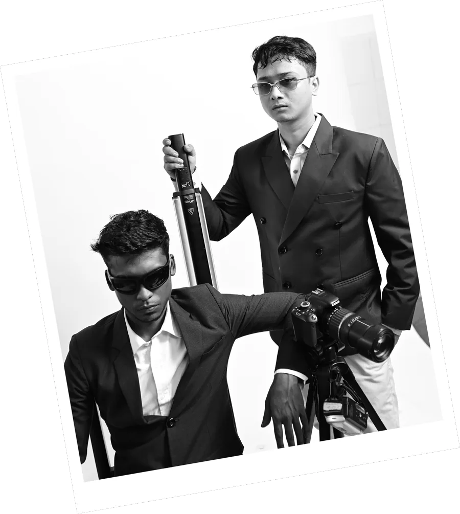 Two Kazi team members with a camera rig, photographed in black and white