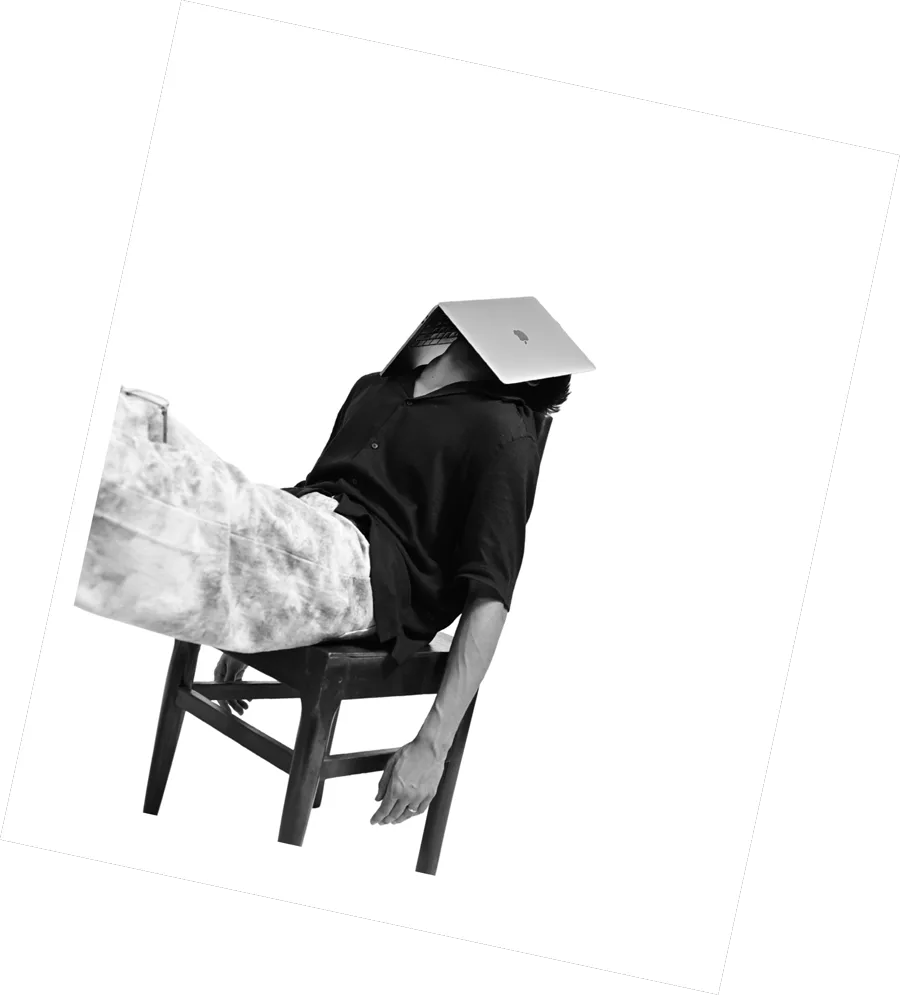 A Kazi team member slouched in a chair with a laptop resting over their face