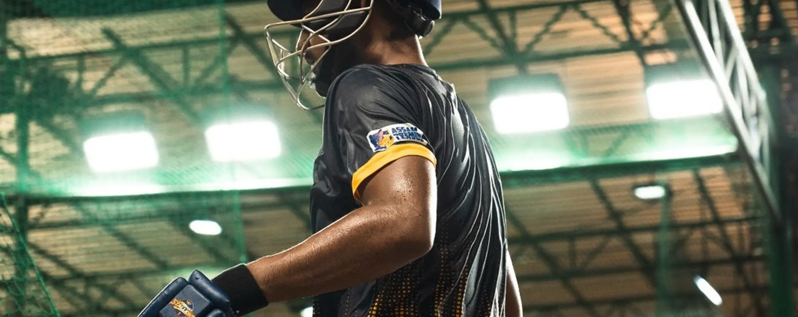 A Jorhat Stallions batter in the practice nets under floodlights