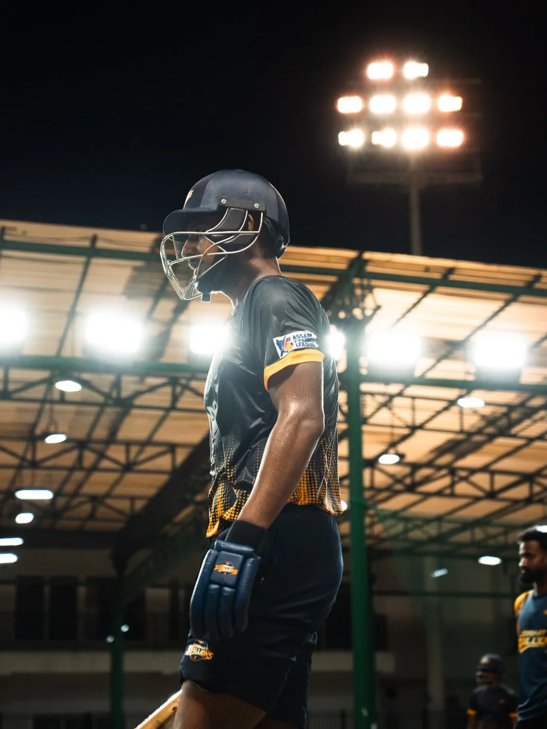 Jorhat Stallions batter walking out under the floodlights