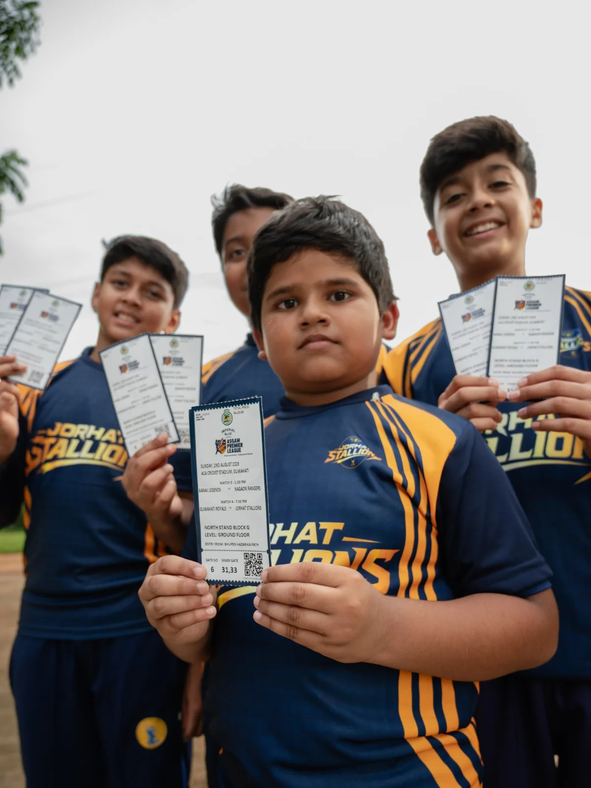 Young supporter holding up a match ticket