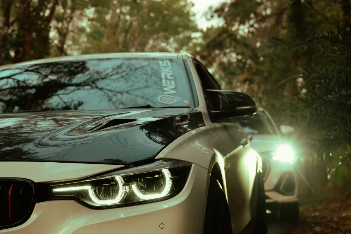 BMW with 9WERKS windshield banner, headlights on