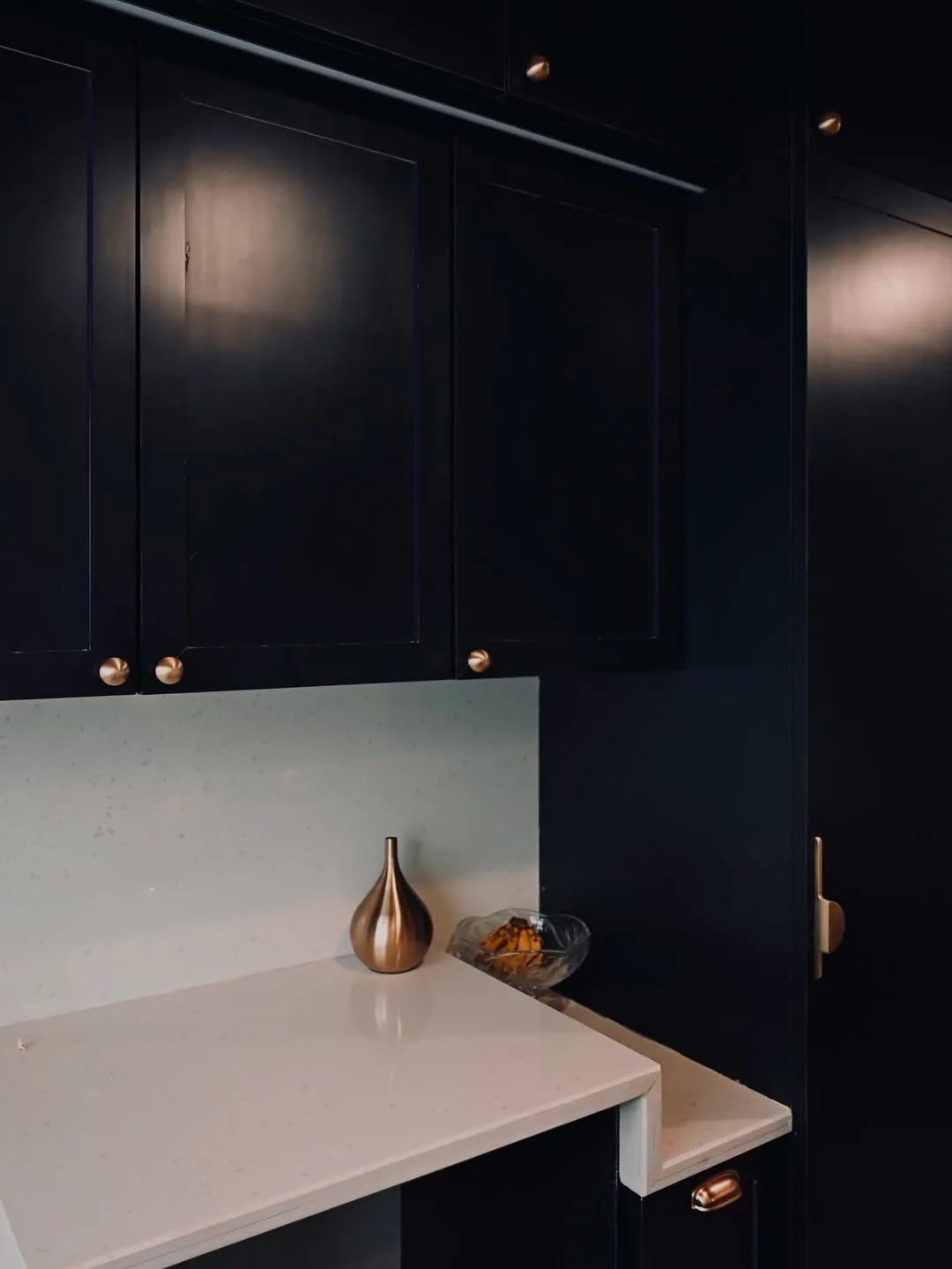 Navy cabinetry with brass hardware